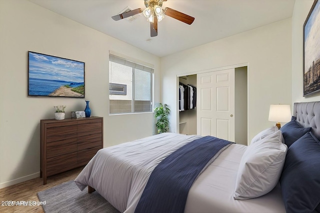 bedroom with a ceiling fan, a closet, baseboards, and wood finished floors