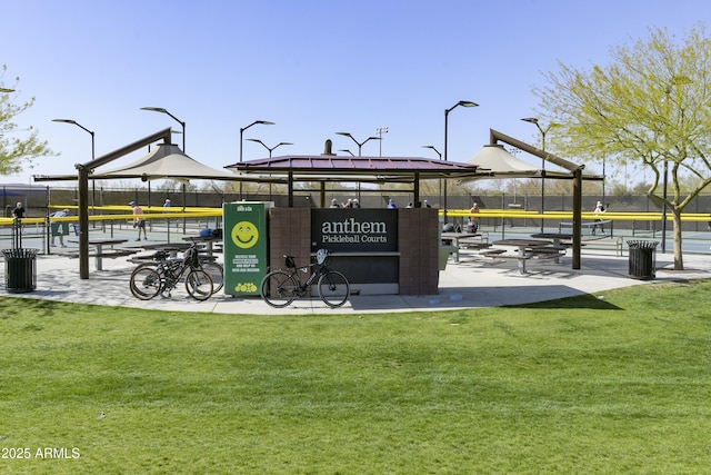 surrounding community with playground community, a lawn, a gazebo, and fence