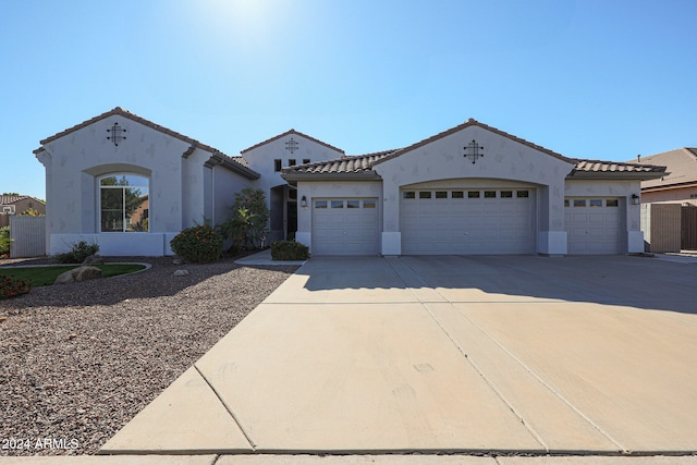 mediterranean / spanish home with a garage