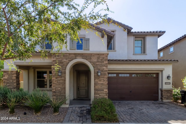 mediterranean / spanish-style home with a garage