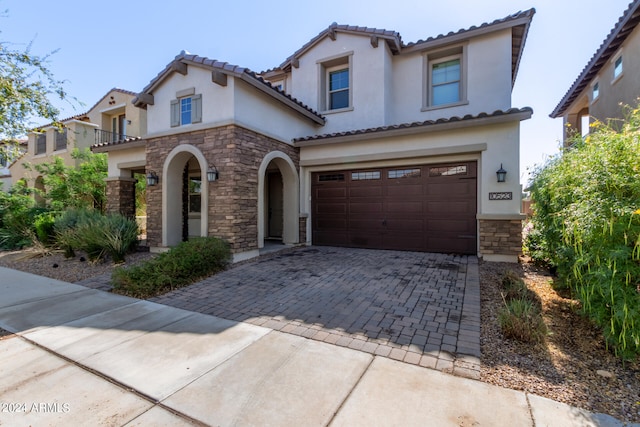 mediterranean / spanish house with a garage