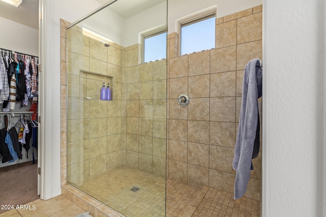 bathroom featuring tile patterned floors and a shower with shower door