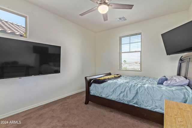 bedroom featuring carpet, multiple windows, and ceiling fan