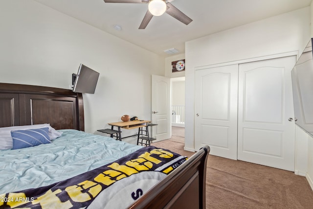 bedroom with a closet, light colored carpet, and ceiling fan