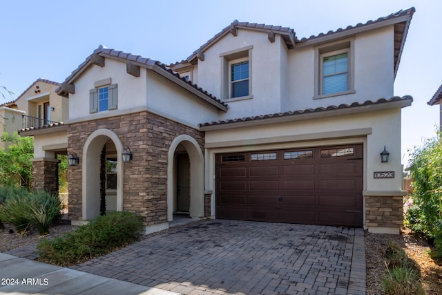 mediterranean / spanish-style home featuring a garage