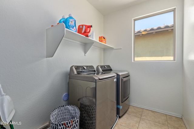 laundry room with light tile patterned floors and separate washer and dryer