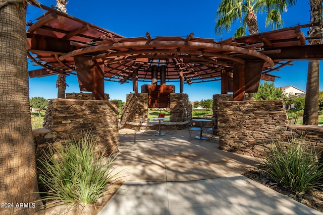 view of patio / terrace featuring a stone fireplace