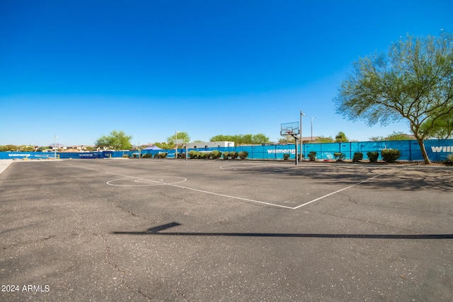 view of vehicle parking with basketball court