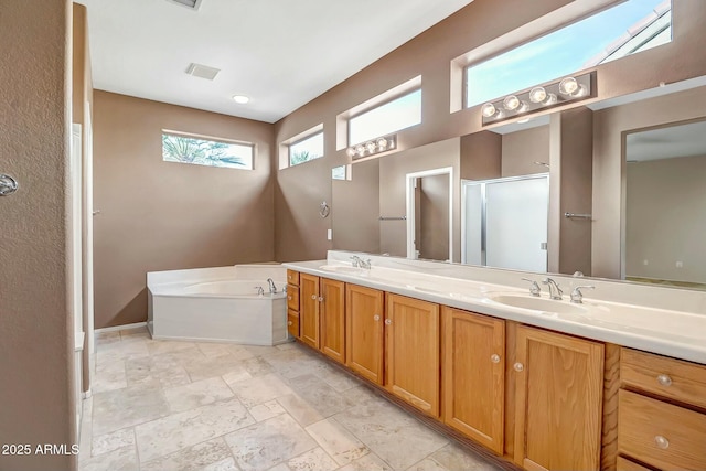 bathroom featuring plus walk in shower and vanity