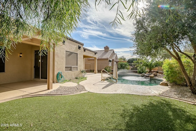 view of yard with pool water feature, a fenced in pool, and a patio