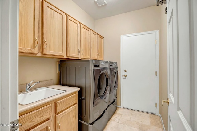 laundry room with cabinets, washing machine and clothes dryer, and sink