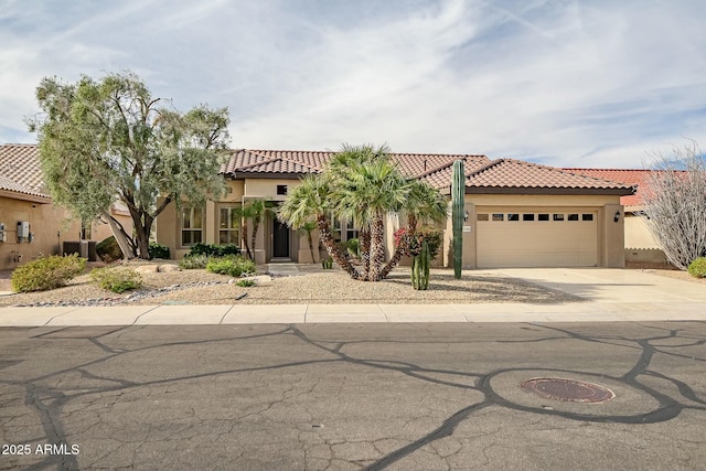 mediterranean / spanish-style home with a garage