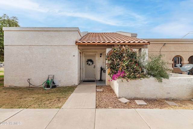 view of front of property featuring a tile roof and stucco siding