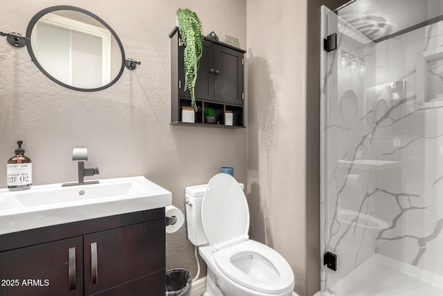 bathroom with vanity, an enclosed shower, and toilet