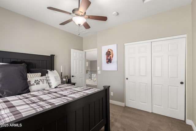 carpeted bedroom with ceiling fan and a closet