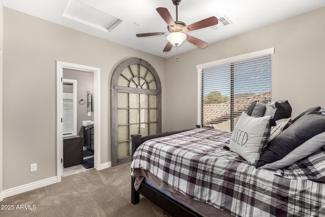 bedroom with light colored carpet, ceiling fan, and ensuite bathroom