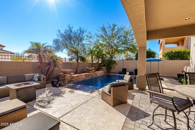 view of swimming pool with an outdoor living space with a fire pit and a patio area