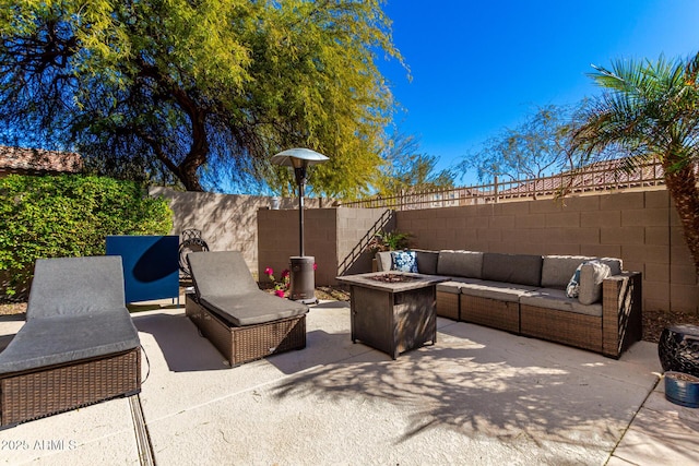 view of patio with an outdoor living space with a fire pit