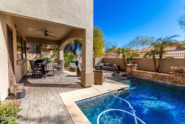 view of pool with ceiling fan and a patio area