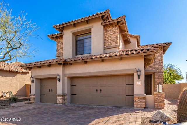 mediterranean / spanish home with a garage