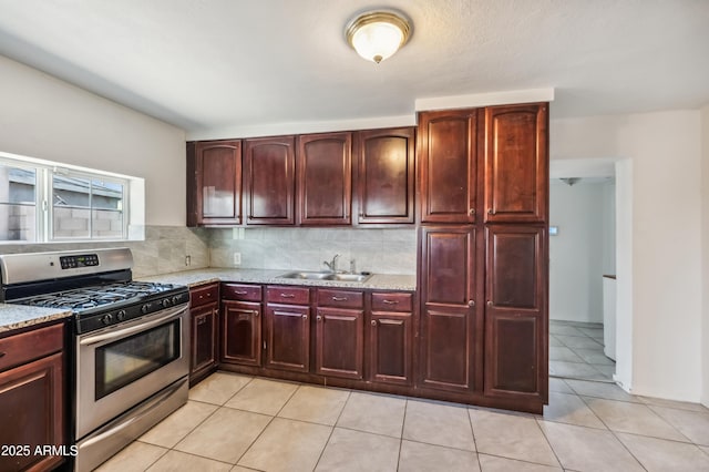 4441 S 8th St, Phoenix, AZ 85040 - kitchen featuring stainless steel range with gas stovetop, a sink, dark brown cabinets, light stone counters, and tasteful backsplash