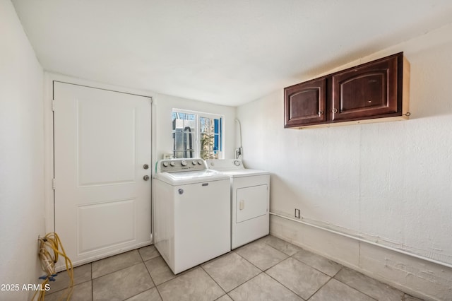 4441 S 8th St, Phoenix, AZ 85040 - laundry area featuring washing machine and dryer, light tile patterned floors, and cabinet space