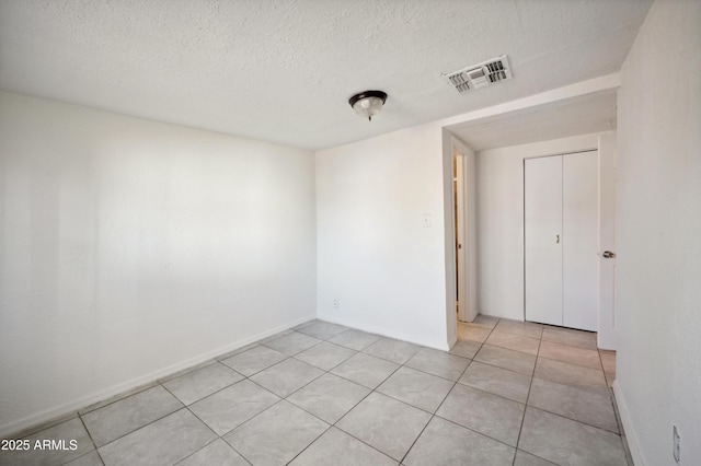 4441 S 8th St, Phoenix, AZ 85040 - empty room featuring a textured ceiling, light tile patterned flooring, and baseboards