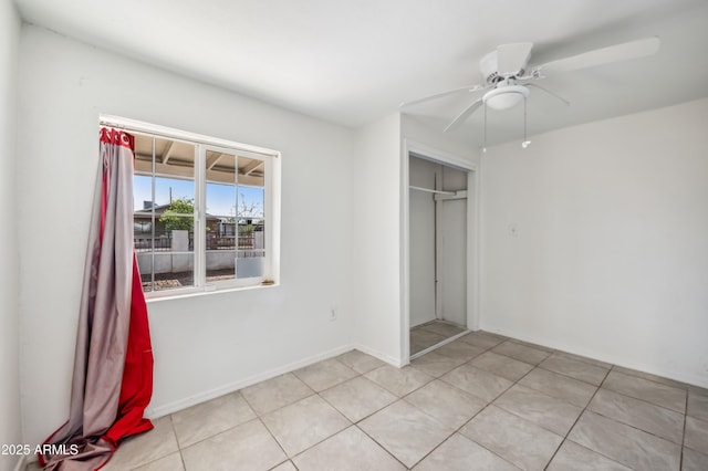 4441 S 8th St, Phoenix, AZ 85040 - unfurnished bedroom with a closet, a ceiling fan, light tile patterned floors, and baseboards