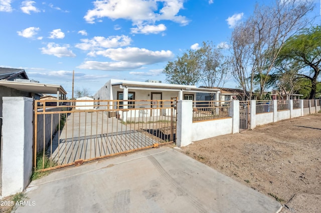 4441 S 8th St, Phoenix, AZ 85040 - view of front facade featuring a fenced front yard, a gate, stucco siding, and concrete driveway