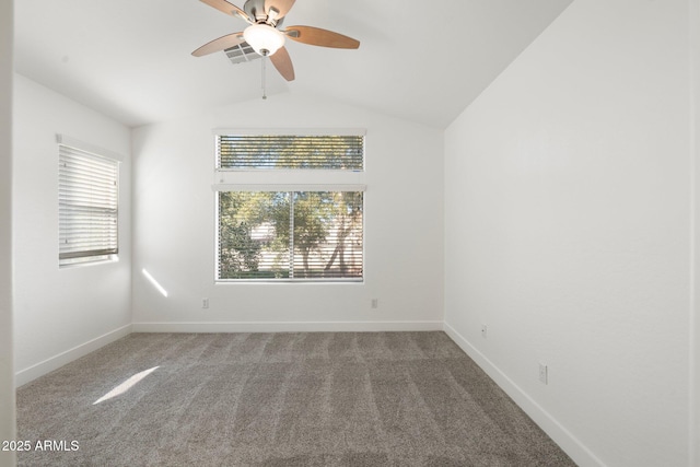 carpeted empty room with vaulted ceiling and ceiling fan