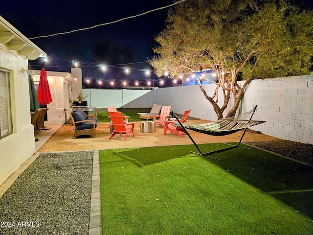 1801 N 87th Pl, Scottsdale, AZ 85257 - yard at night featuring a fenced backyard and a patio