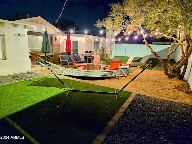 1801 N 87th Pl, Scottsdale, AZ 85257 - yard at night with a patio and an outdoor living space