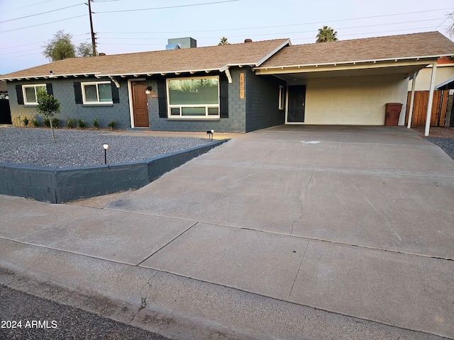 1801 N 87th Pl, Scottsdale, AZ 85257 - ranch-style house with concrete driveway, an attached carport, and roof with shingles