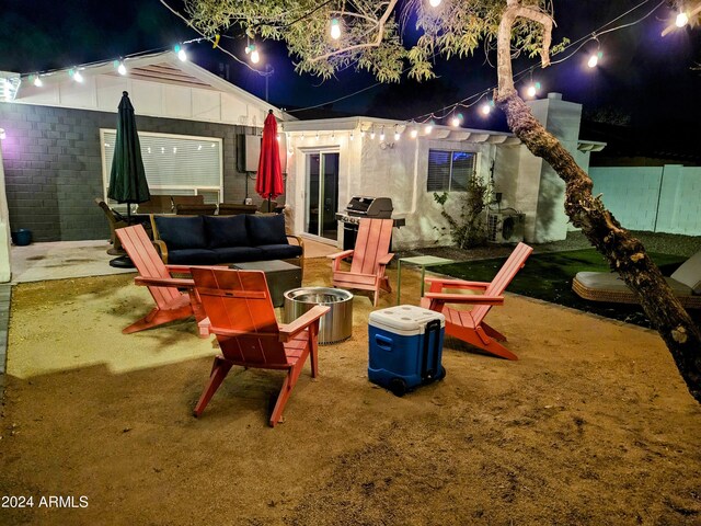1801 N 87th Pl, Scottsdale, AZ 85257 - patio at twilight with area for grilling and an outdoor living space with a fire pit