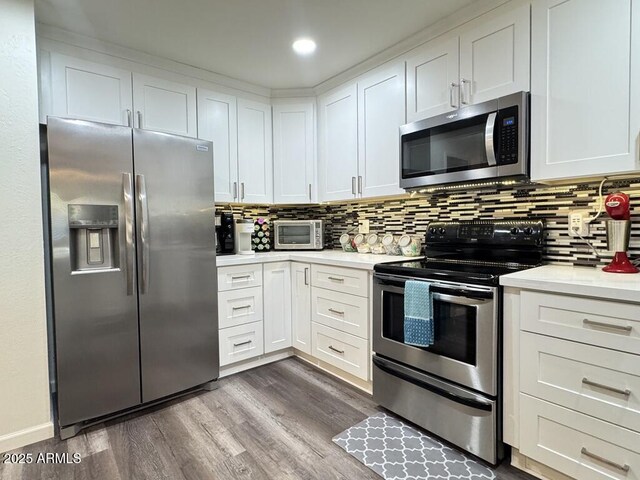 1801 N 87th Pl, Scottsdale, AZ 85257 - kitchen featuring appliances with stainless steel finishes, light countertops, backsplash, dark wood-type flooring, and white cabinetry
