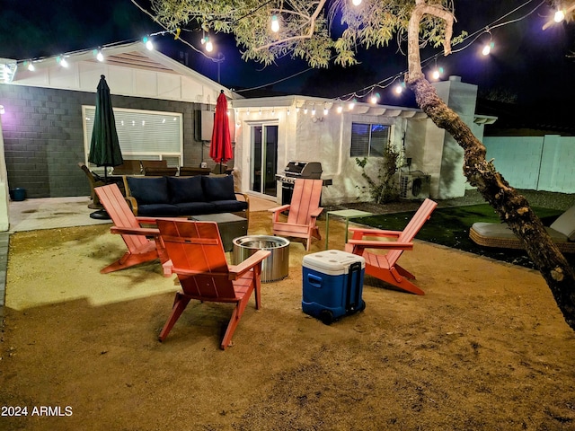 1801 N 87th Pl, Scottsdale, AZ 85257 - patio at twilight with area for grilling and an outdoor living space with a fire pit