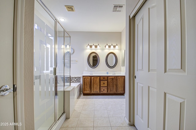 bathroom with visible vents, double vanity, a stall shower, tile patterned flooring, and a bath