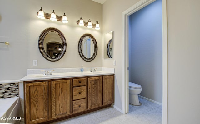 full bathroom with a sink, toilet, double vanity, and tile patterned floors