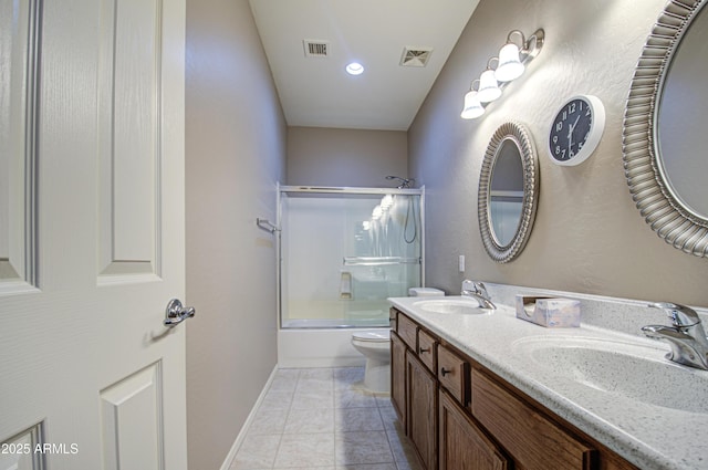 bathroom featuring a sink, visible vents, enclosed tub / shower combo, and toilet