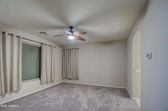 unfurnished room featuring visible vents, a ceiling fan, baseboards, and carpet floors