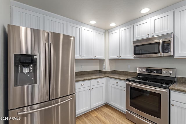 21320 N 56th St Unit 2159, Phoenix, AZ 85054 - kitchen featuring stainless steel appliances, dark countertops, white cabinetry, recessed lighting, and light wood-style floors