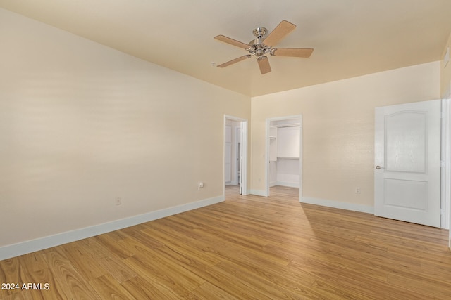 unfurnished room with ceiling fan and light wood-type flooring