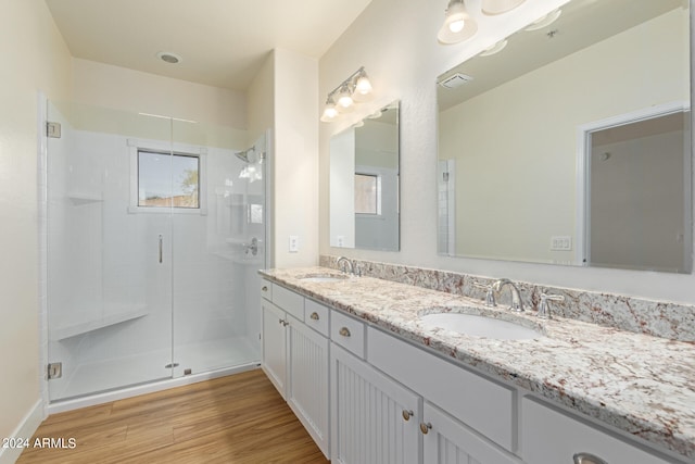 bathroom featuring a shower with shower door, vanity, and hardwood / wood-style floors