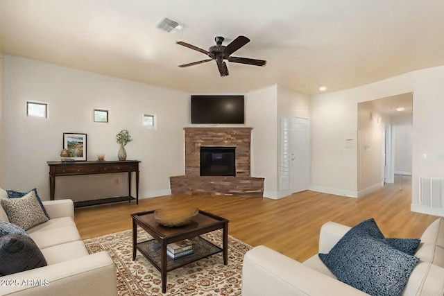 21320 N 56th St Unit 2159, Phoenix, AZ 85054 - living area with a ceiling fan, wood finished floors, a fireplace, and baseboards