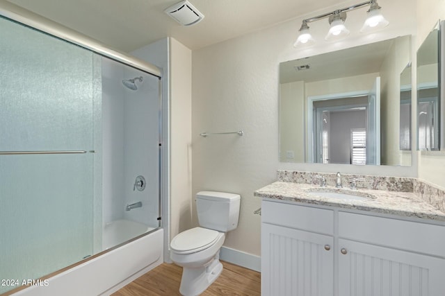 21320 N 56th St Unit 2159, Phoenix, AZ 85054 - bathroom featuring toilet, vanity, wood finished floors, and combined bath / shower with glass door