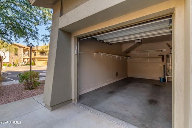 garage featuring gas water heater and a garage door opener