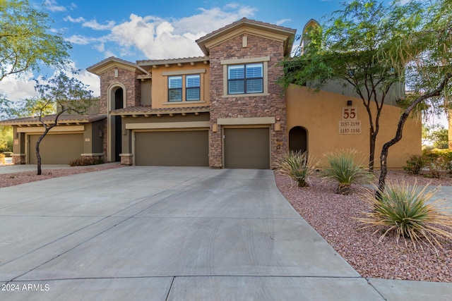 21320 N 56th St Unit 2159, Phoenix, AZ 85054 - view of front of property with stucco siding, an attached garage, a tiled roof, and concrete driveway