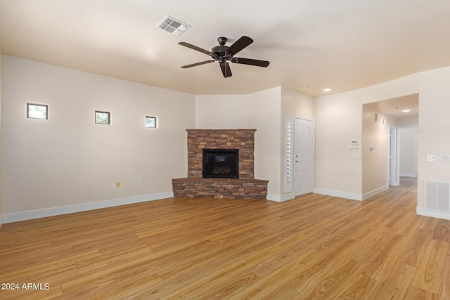 21320 N 56th St Unit 2159, Phoenix, AZ 85054 - unfurnished living room with ceiling fan, a stone fireplace, light wood finished floors, baseboards, and recessed lighting