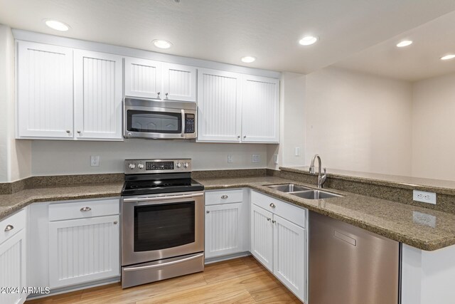 21320 N 56th St Unit 2159, Phoenix, AZ 85054 - kitchen featuring stainless steel appliances, a sink, a peninsula, white cabinetry, and recessed lighting