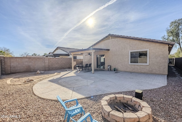 back of house with a patio and a fire pit